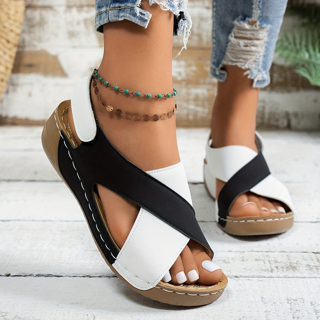 Overhead flat-lay of Olive wedge sandals in black showing full silhouette and strap layout