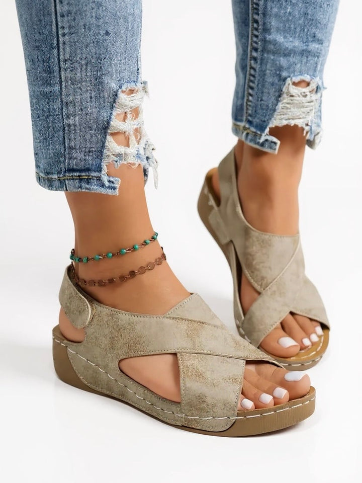 Olive platform wedge sandals in light brown shown from the front on a white background
