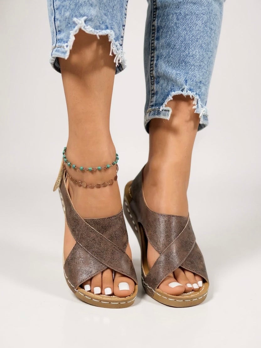 Olive platform wedge sandals in black styled on a model's feet