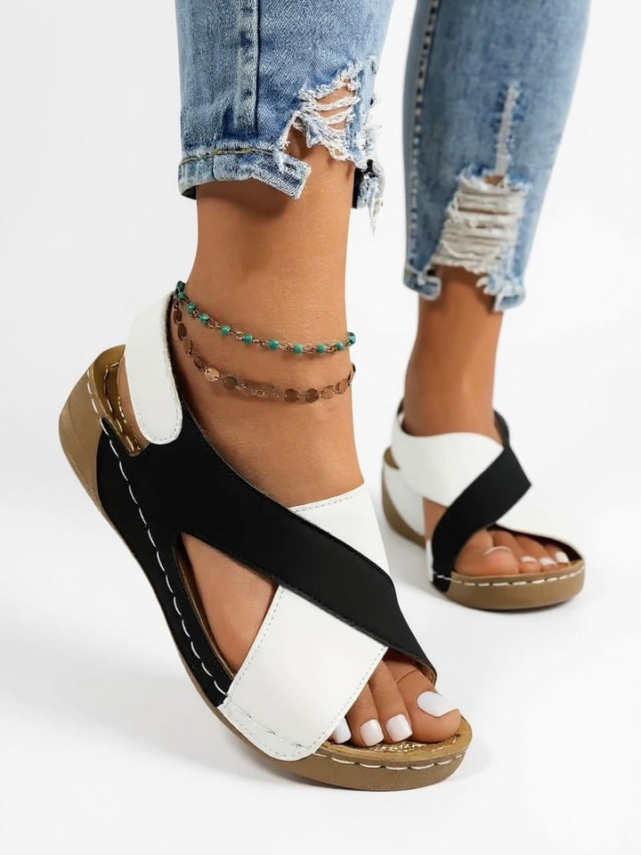 Olive platform wedge sandals in navy blue on a neutral surface