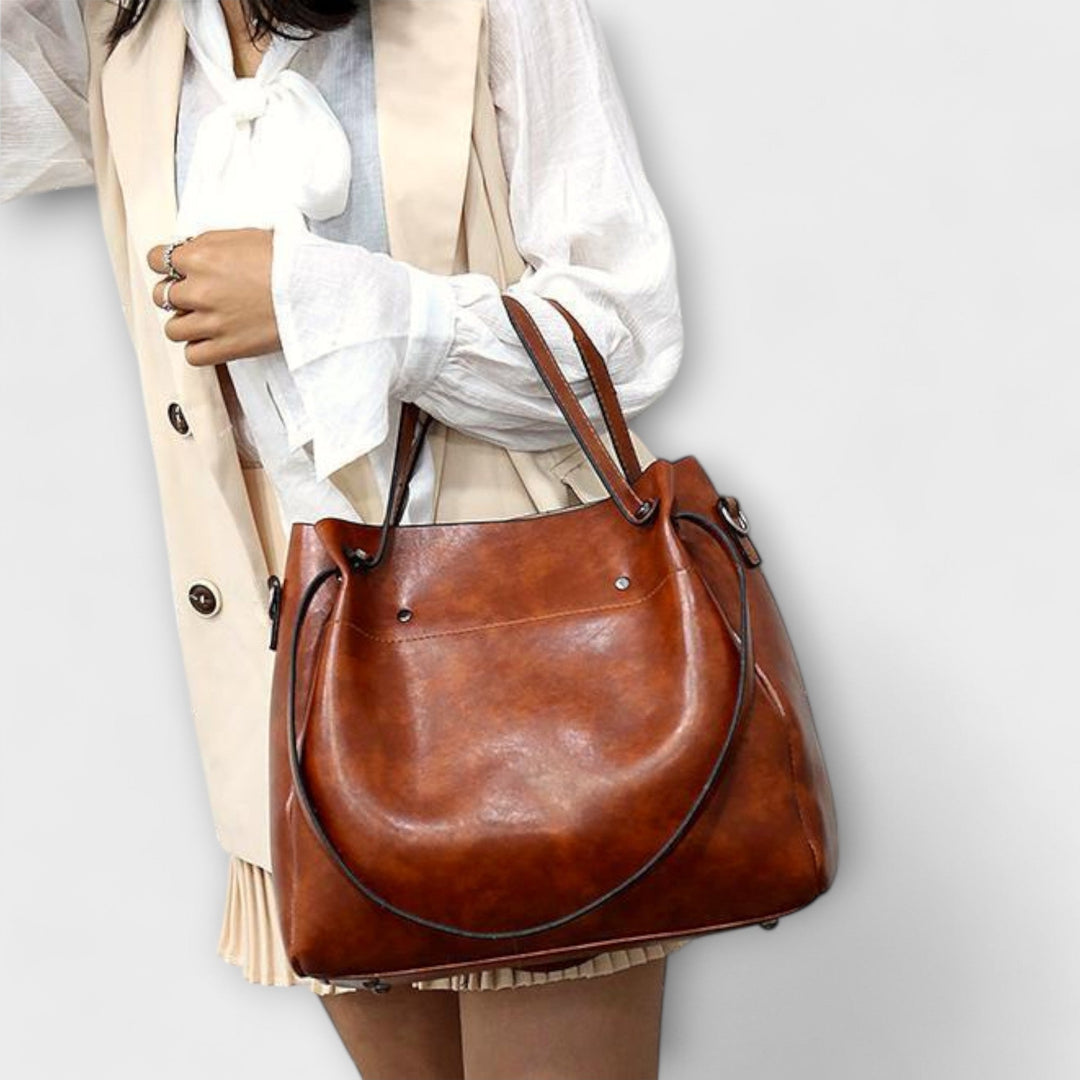 Side view of the Olivia tote bag showing depth and handles in gray