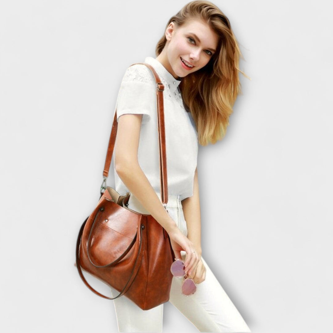 Overhead flat lay of the full Olivia 4-piece bag set in black on a neutral background