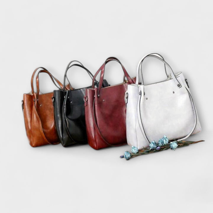 Model holding the Olivia tote bag in gray with both hands showing scale and size