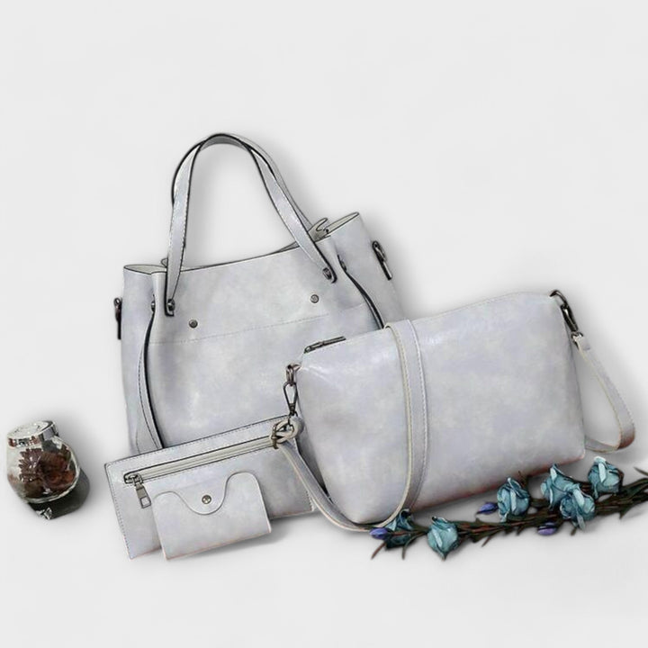 Lifestyle shot of the Olivia 4-piece vintage bag set in black styled for travel