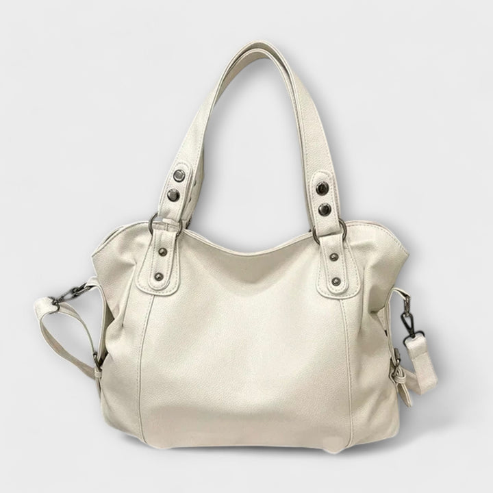 Beige soft faux-leather hobo shoulder bag with adjustable strap on a clean background