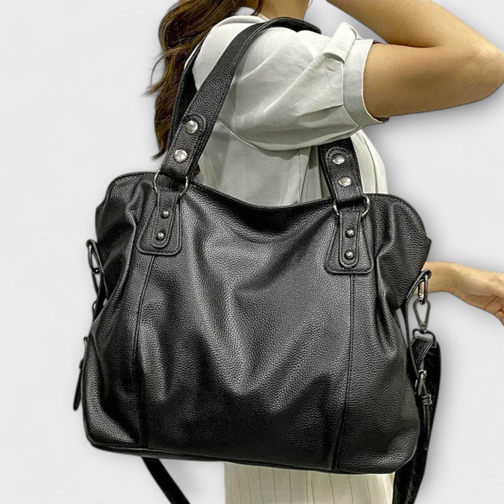Black sleek shoulder bag with multiple compartments shown from the front