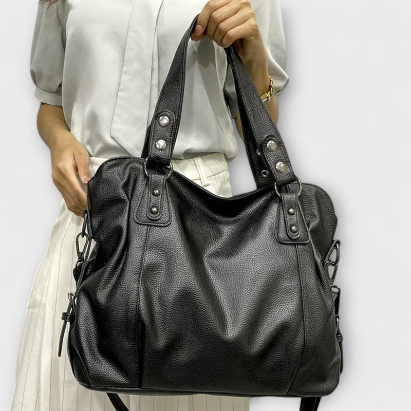 Khaki large-capacity shoulder bag with structured silhouette on a neutral backdrop