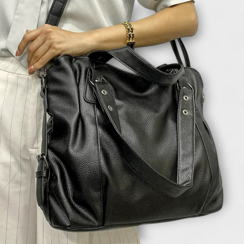Brown faux-leather hobo shoulder bag displayed at a slight angle showing strap detail