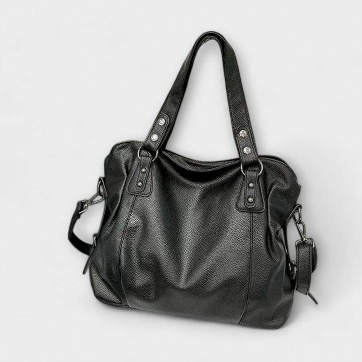 Interior view of the Olivia shoulder bag showing multiple compartments in brown