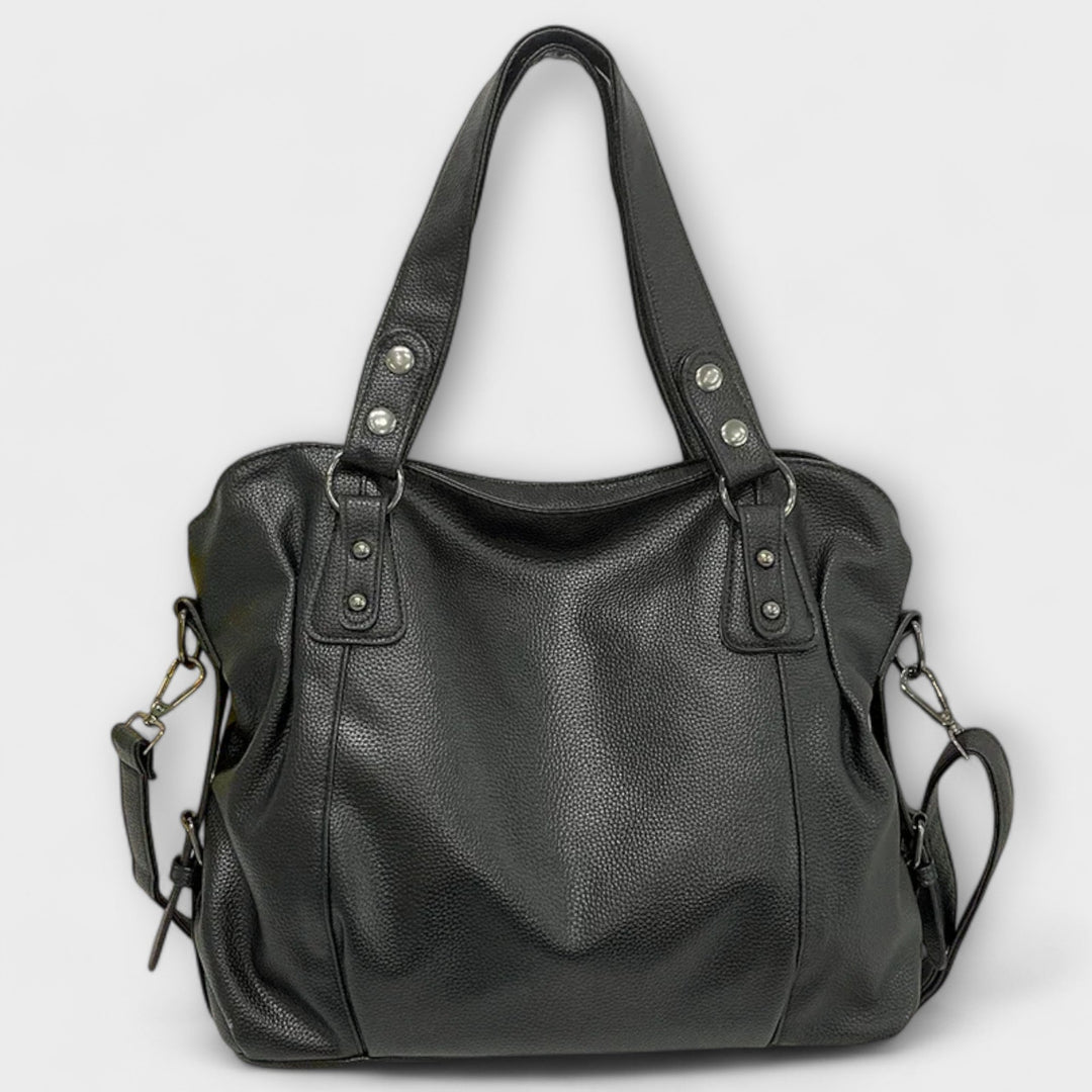 Flat-lay of the Olivia shoulder bag in khaki next to everyday essentials