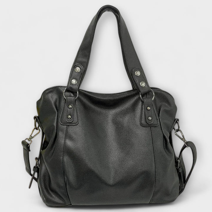 Flat-lay of the Olivia shoulder bag in khaki next to everyday essentials