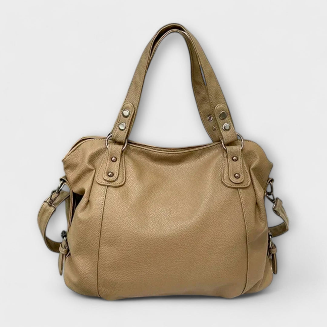 Side profile of the Olivia shoulder bag in black showing depth and structure