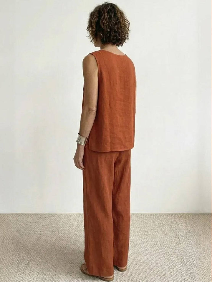Model wearing the Olivia set in rusty orange with white sneakers