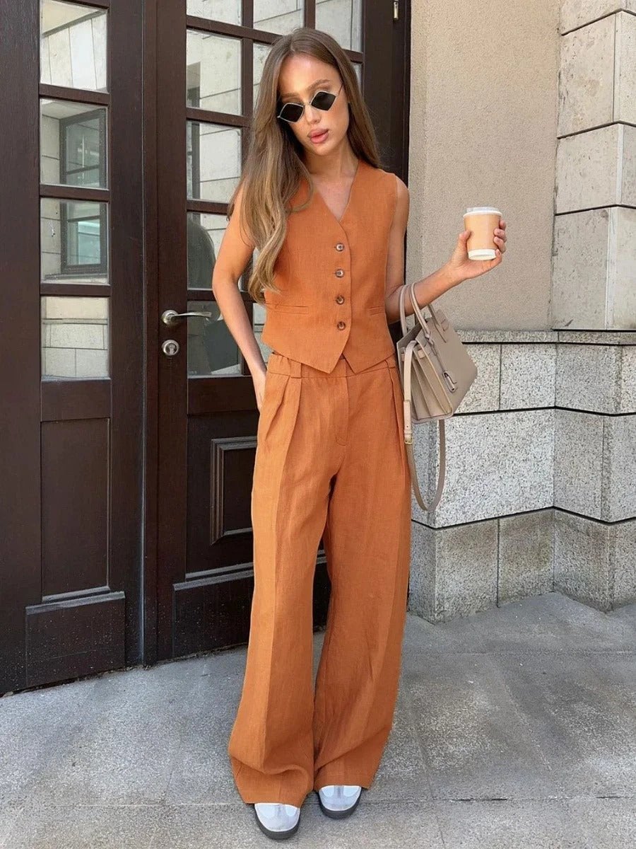 Model styled in the orange Effortless Chic Two-Piece Set against a bright summer backdrop