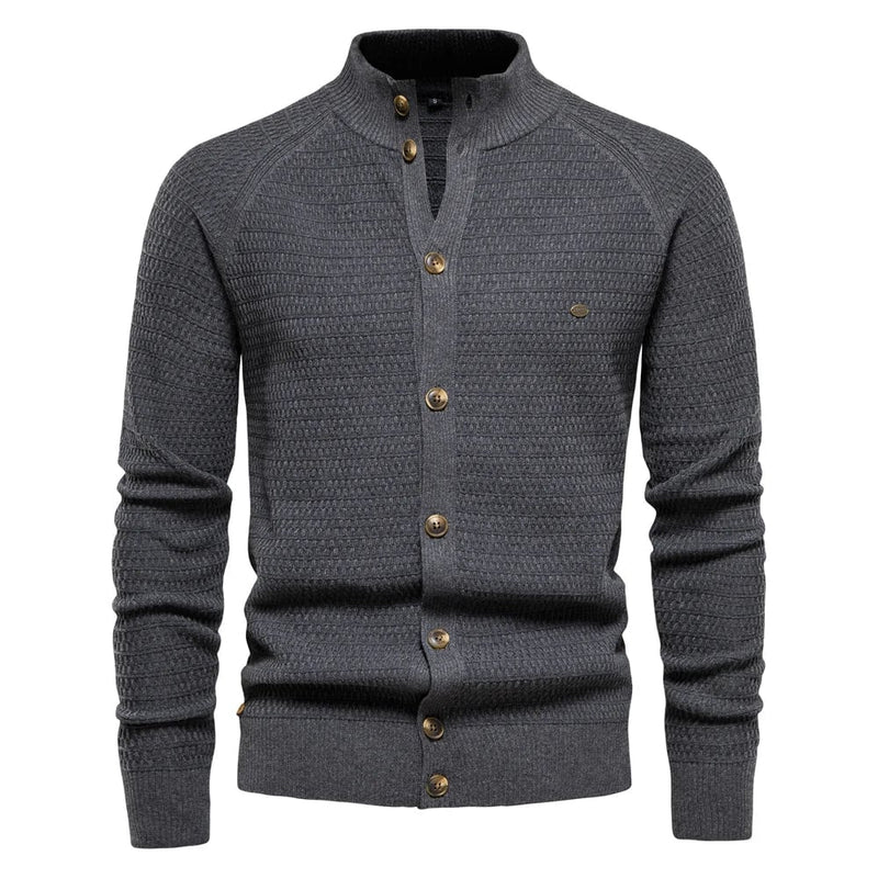 Front view of a luxe cable-knit button vest in navy blue with a classic V-neck and slim-fit silhouette