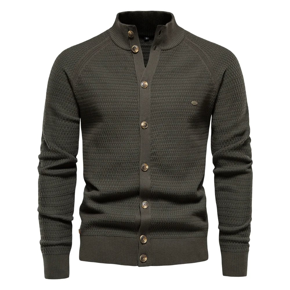 Close-up detail of the subtle cable-knit texture and refined button closure on the luxe vest