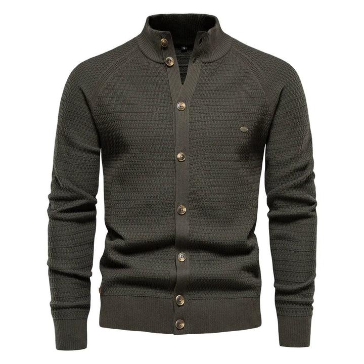Close-up detail of the subtle cable-knit texture and refined button closure on the luxe vest