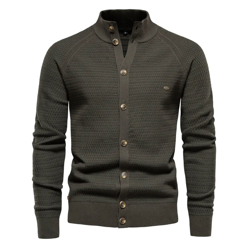 Close-up detail of the subtle cable-knit texture and refined button closure on the luxe vest