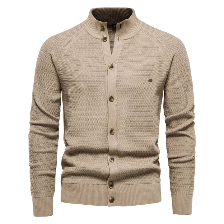 Model wearing the luxe cable-knit vest in khaki layered over a white shirt for a smart casual look