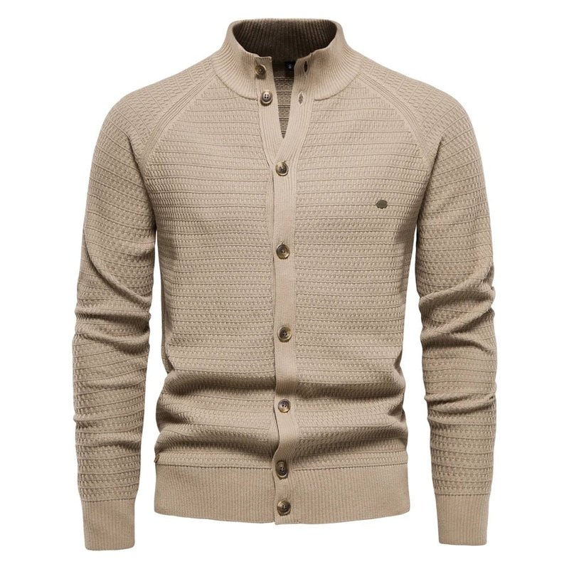 Model wearing the luxe cable-knit vest in khaki layered over a white shirt for a smart casual look