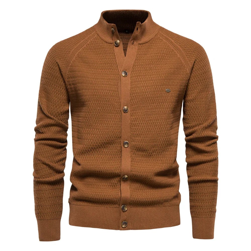 Flat lay of the luxe cable-knit vest in green showing the full button-front closure and V-neck design