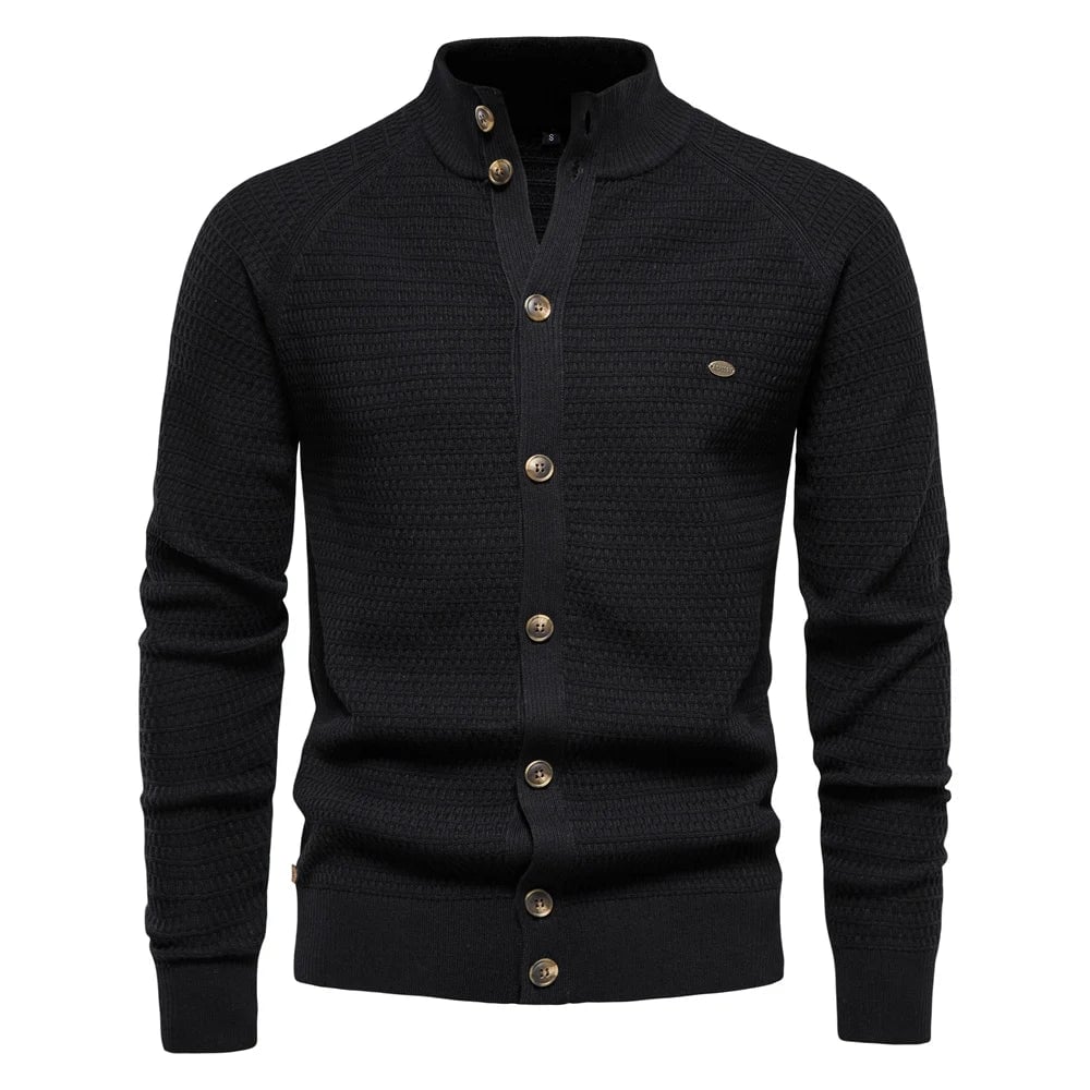 Model styling the cable-knit vest in black over a casual white tee for a relaxed everyday outfit