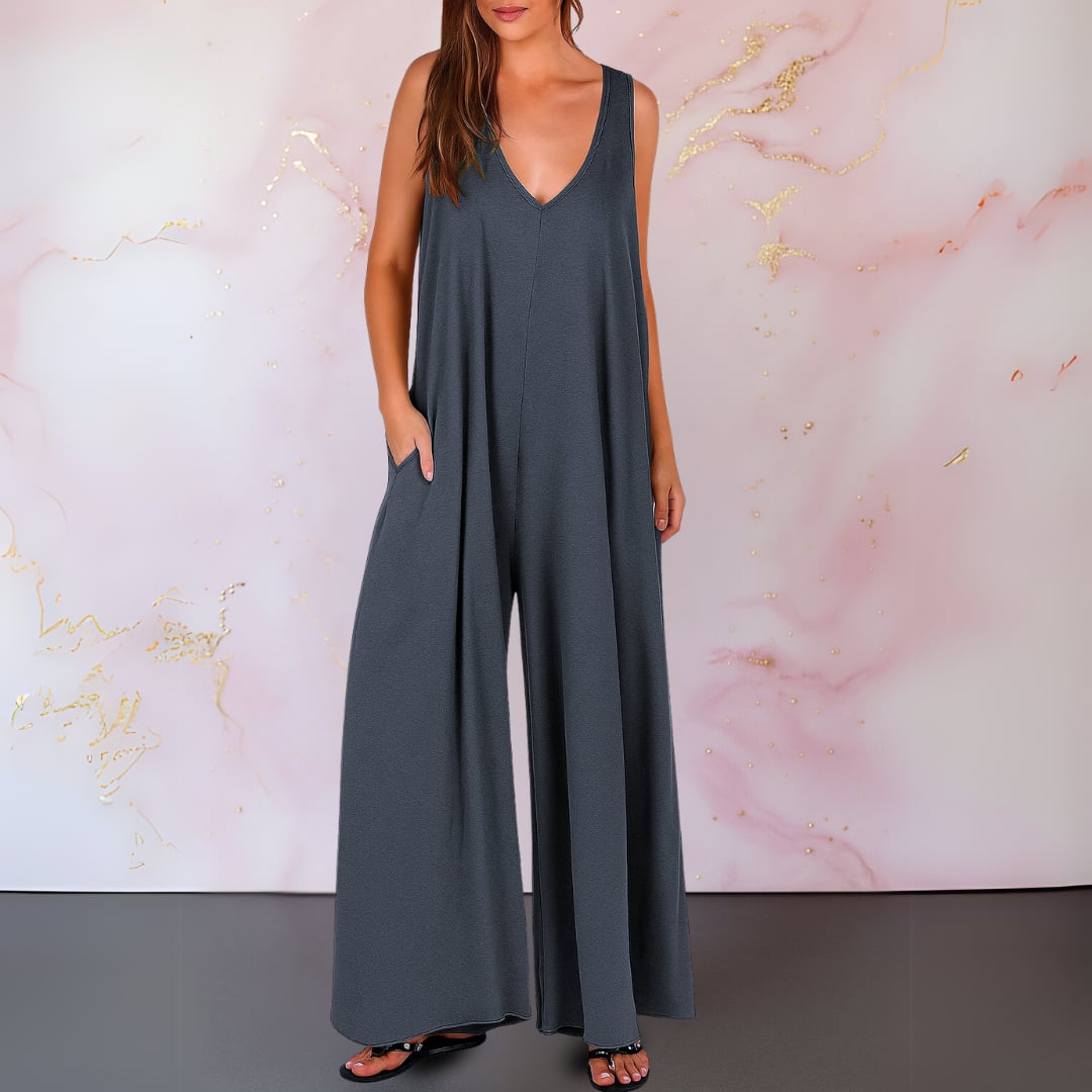Close-up of the deep V-neckline detail on a black sleeveless jumpsuit