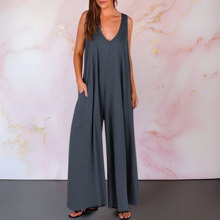 Close-up of the deep V-neckline detail on a black sleeveless jumpsuit