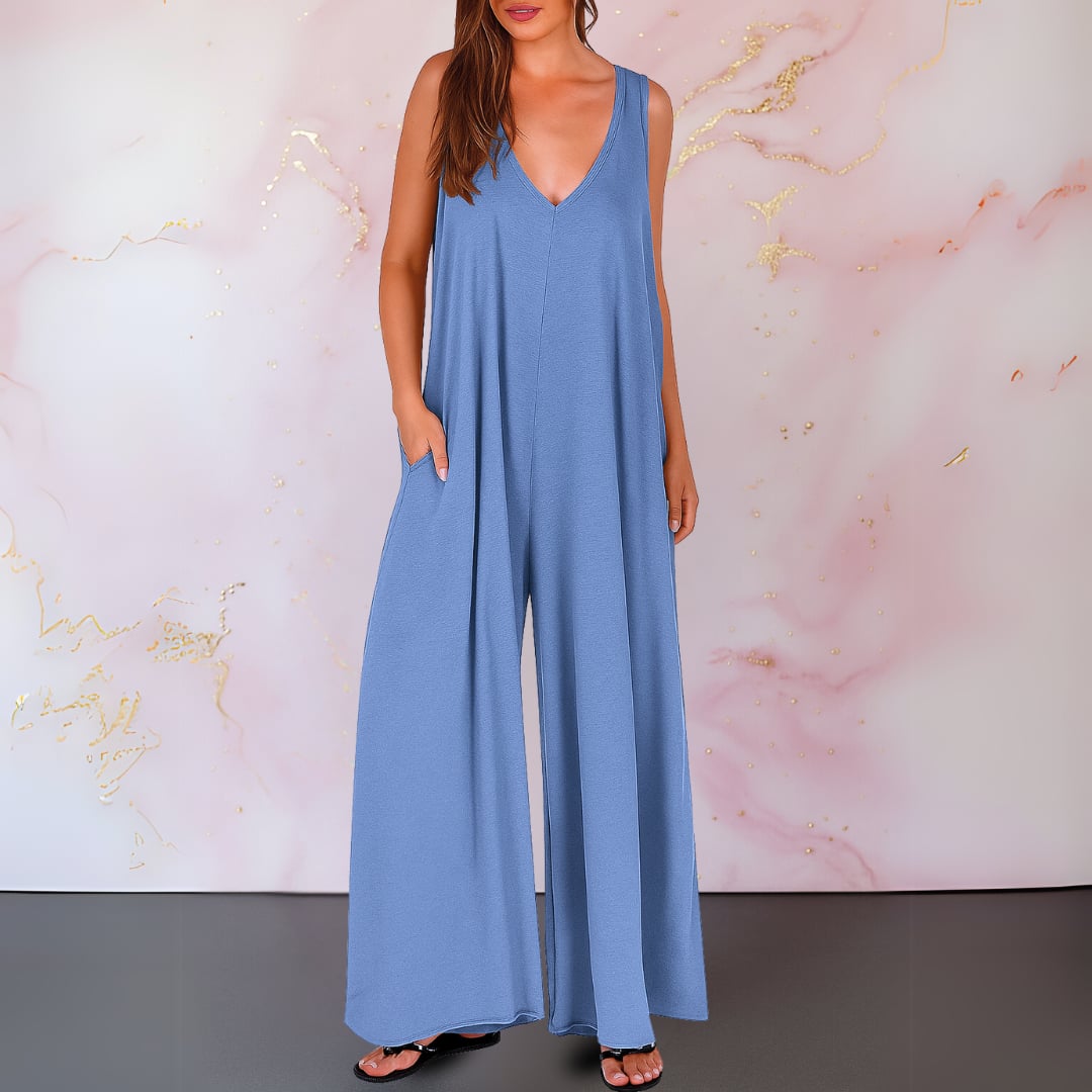 Side view showing the flowing wide-leg silhouette and hidden side pocket of a black jumpsuit