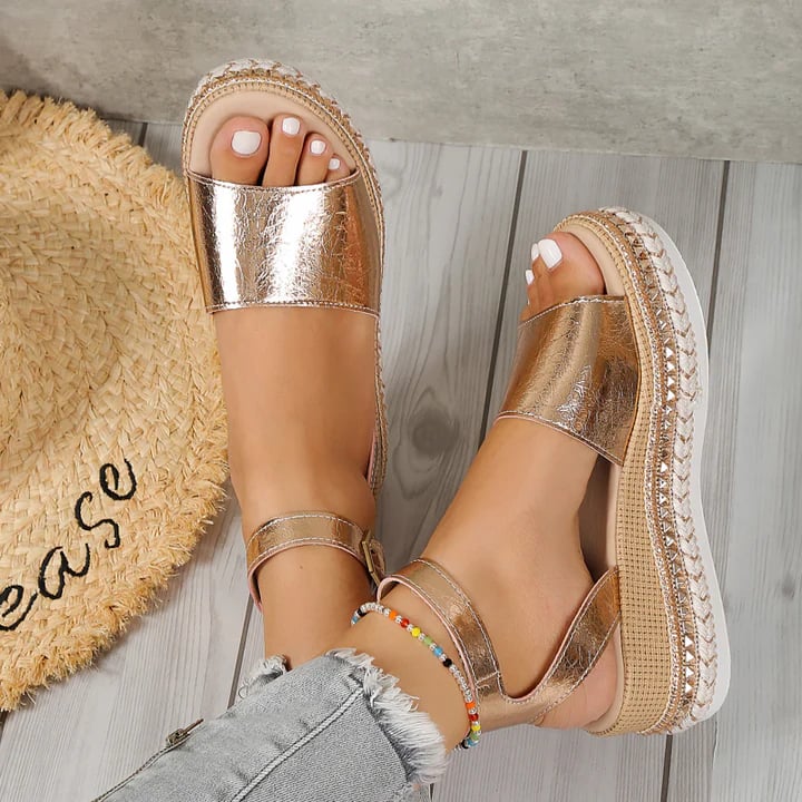 Close-up of the Opal sandal's adjustable buckle strap and memory foam insole in gold