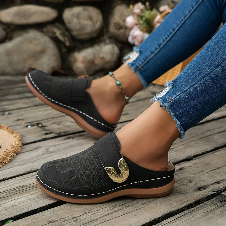 Close-up of Ophelia wedge sandal adjustable buckle strap detail in black