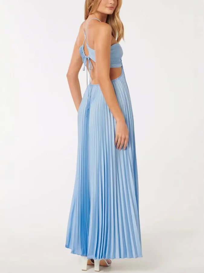 Full-length shot of a woman in a blue halter maxi dress styled for a wedding guest look