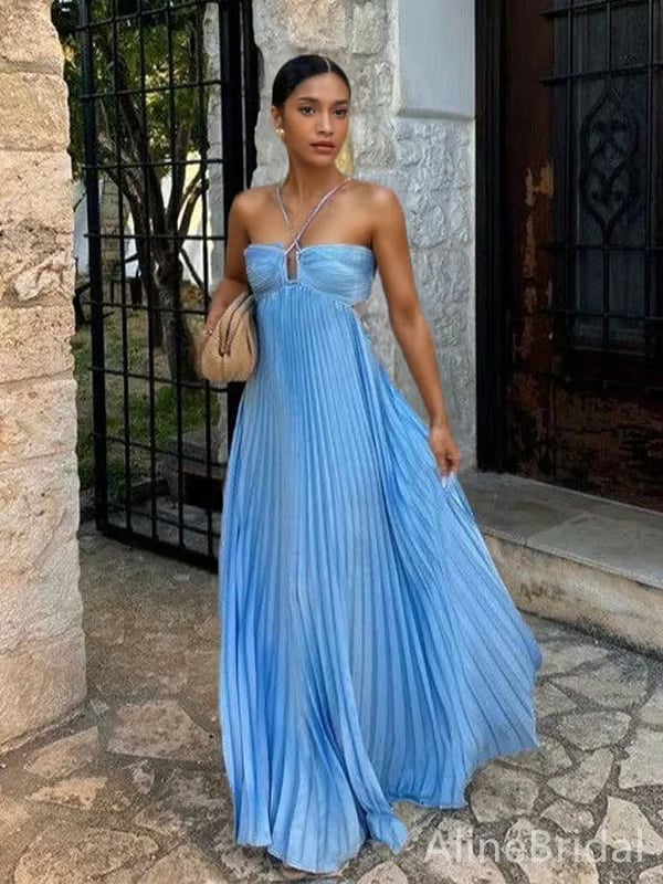 Woman in a blue halter maxi dress posing outdoors in natural light
