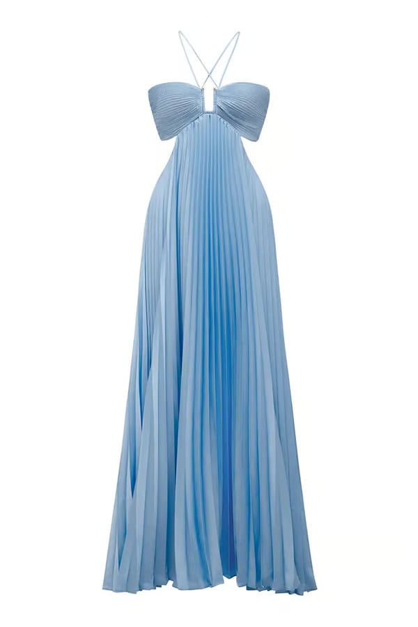 Detail shot of the flowing skirt of a blue halter maxi dress in motion