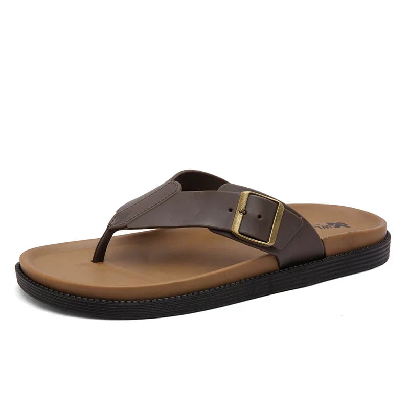 Orla sandals in black styled with a flowy summer dress on a warm-toned surface