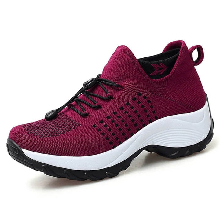 Red orthopedic women's shoes with ergonomic arch support, displayed on white background