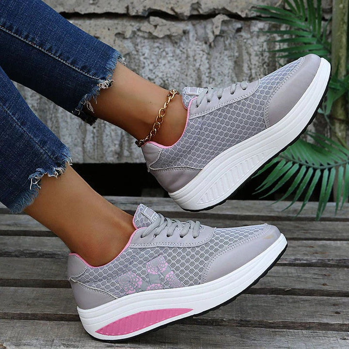 Woman wearing Ottilie orthopedic sneakers in black paired with casual jeans