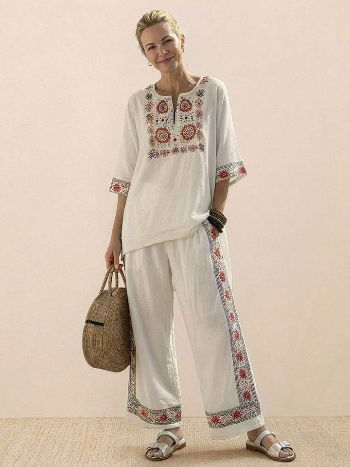 Front view of the Paloma wide-leg pants and tee set in Neutral Stripes on a female model