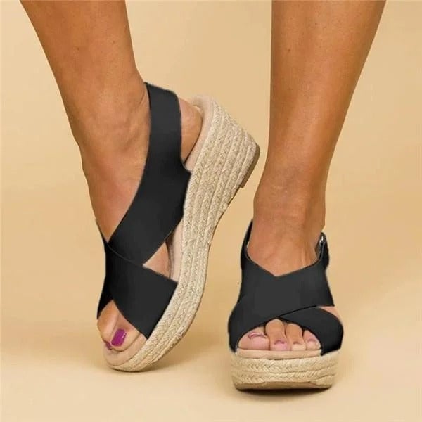 Close-up of Paloma espadrille wedge sandal in black showing woven jute wedge and cross straps