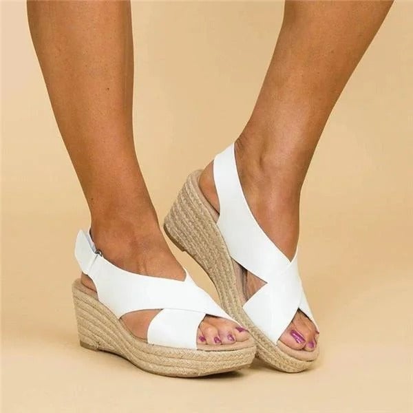 Paloma wedge sandal in brown worn on foot, showcasing cushioned footbed and slingback strap