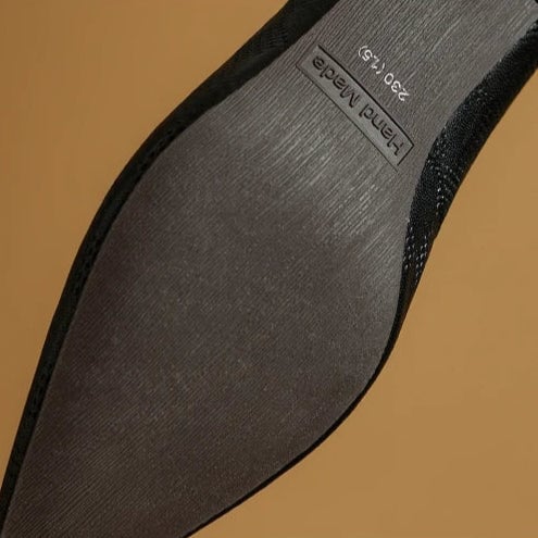 Paloma pointed toe kitten heel pumps in black, side profile view showing textured panels
