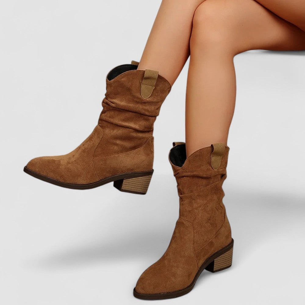 Stylish mid-calf boots in brown with a sleek contoured silhouette, side view
