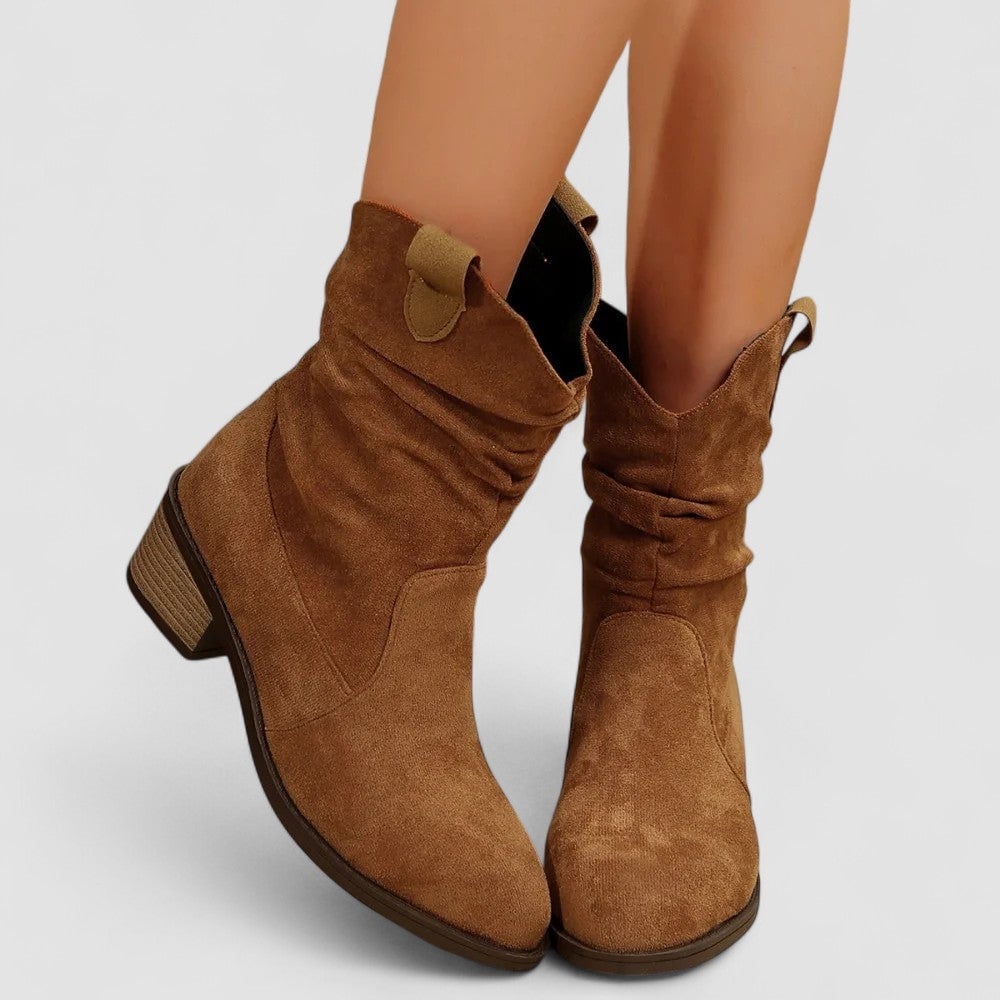 Black mid-calf boots paired with slim trousers for an office-ready outfit