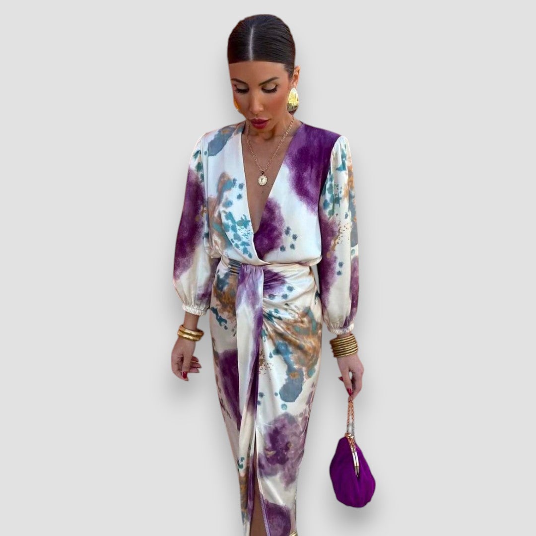 Close-up of the floral blouse and midi skirt set showing the deep V-neck, cinched waist, and graceful skirt drape