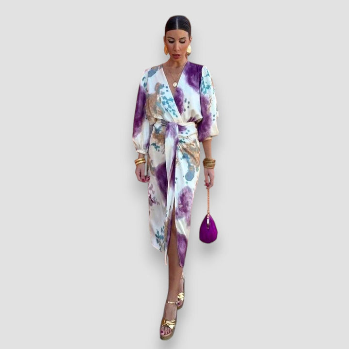 Flat lay or detail shot of the elegant floral two-piece blouse and midi skirt set showing fabric print and texture