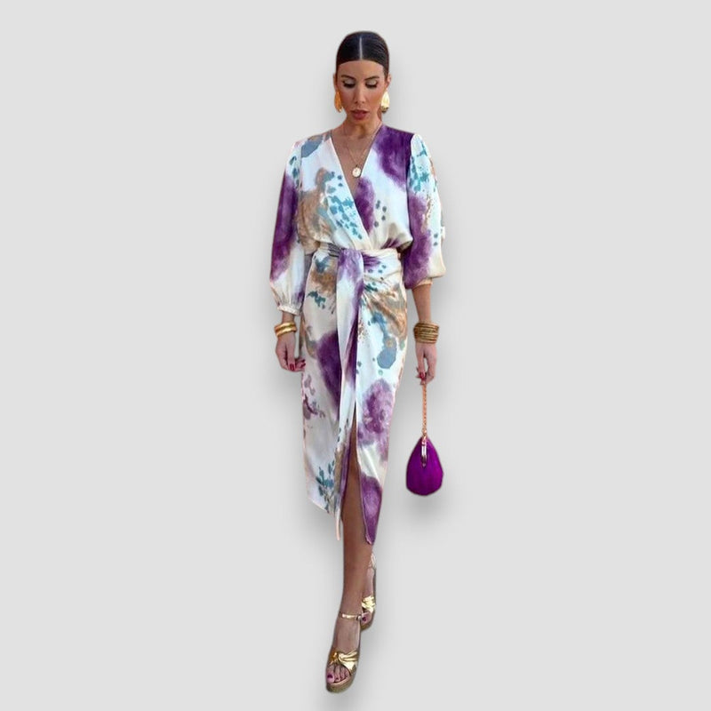 Flat lay or detail shot of the elegant floral two-piece blouse and midi skirt set showing fabric print and texture