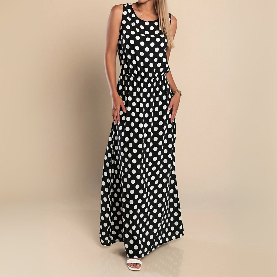 Front view of a black polka dot maxi dress with relaxed silhouette