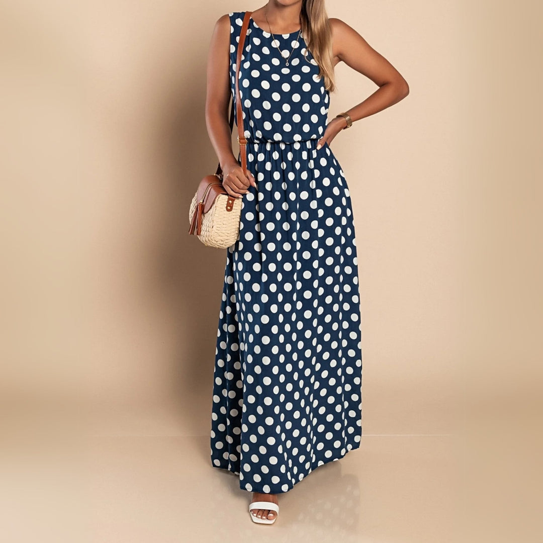 Model in a blue polka dot maxi dress styled with strappy sandals