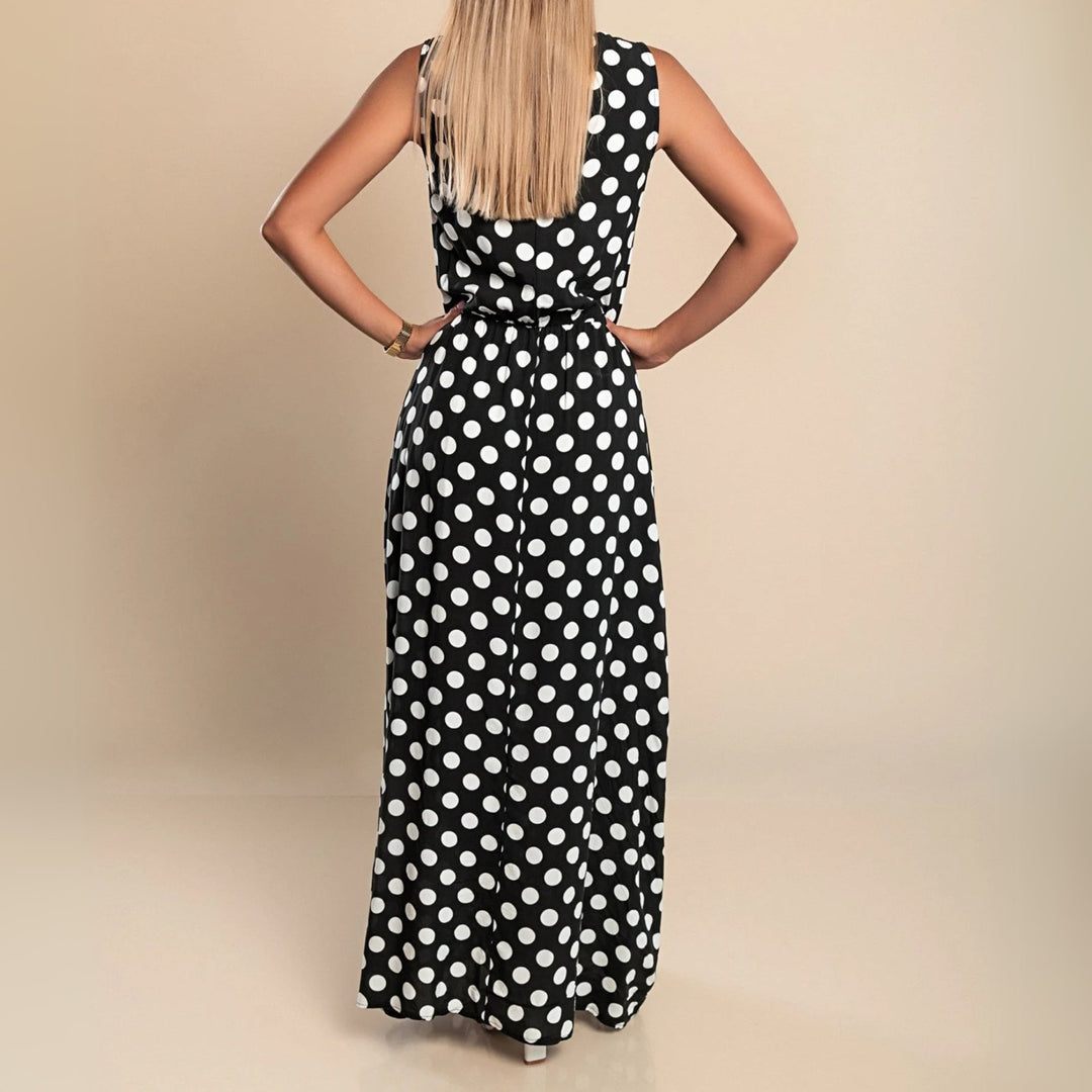Woman twirling in a brown polka dot maxi dress showing movement and length