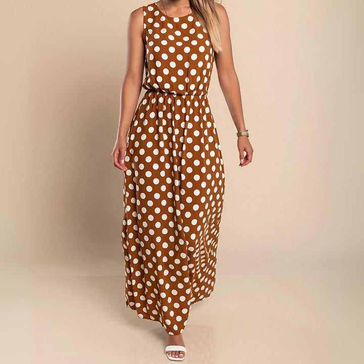 Casual styling of a blue polka dot maxi dress with flat sandals